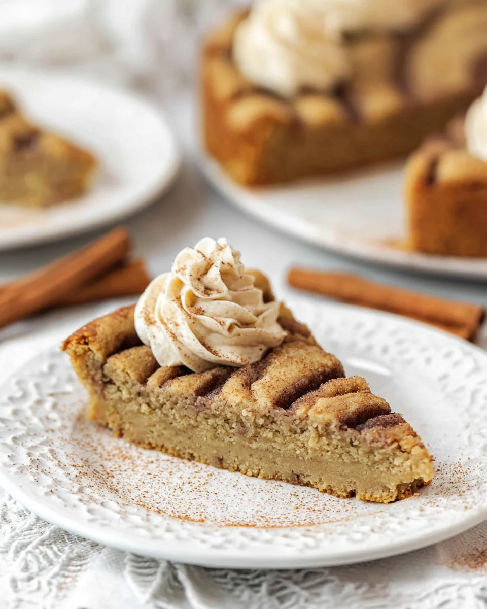 A slice of cinnamon roll cookie cake on a plate