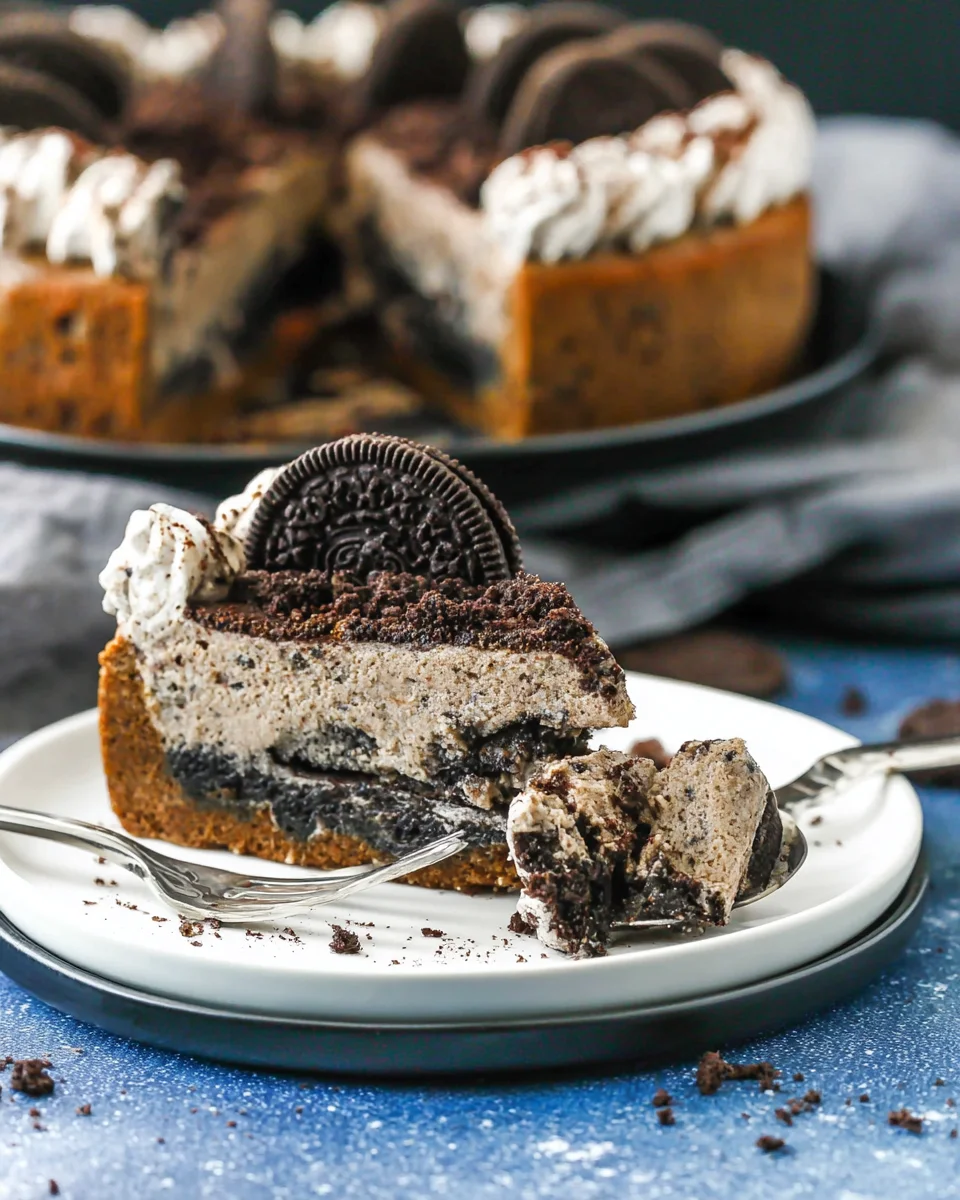 A slice of Oreo cookie cake with a piece on a fork