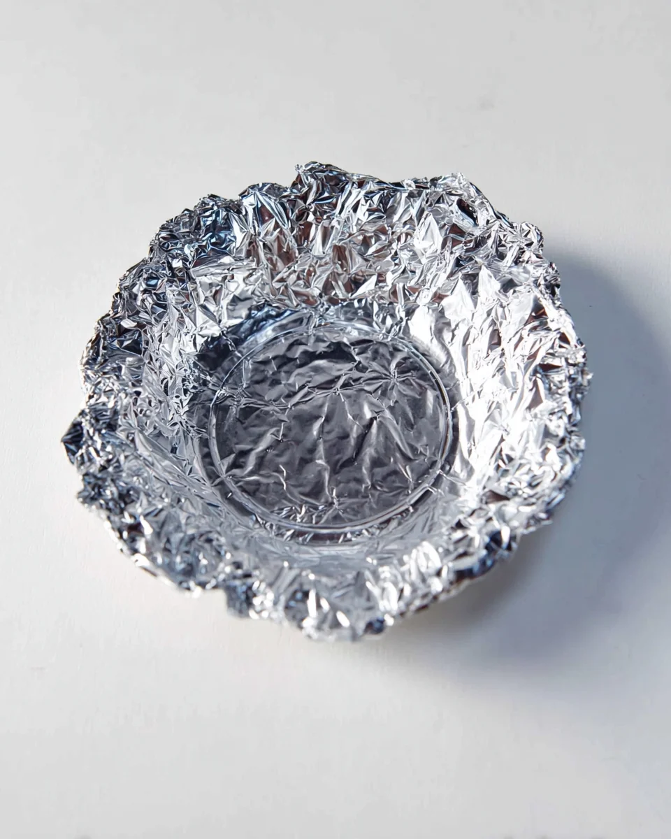 Overhead view of the pie plate with foil placed inside.