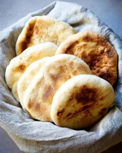 A bowl of freshly baked pita bread.