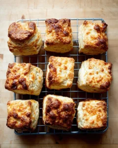 Just-baked buttermilk biscuits on a cooling rack.