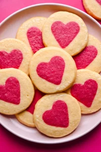 Soft sugar cookies with pink heart designs, perfect for Valentine's Day.