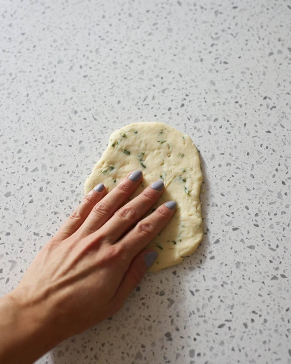 Sourdough-Discard-Garlic-Pull-Apart-Bread-Flatten.jpg Dough pressed into a small, flat circle.