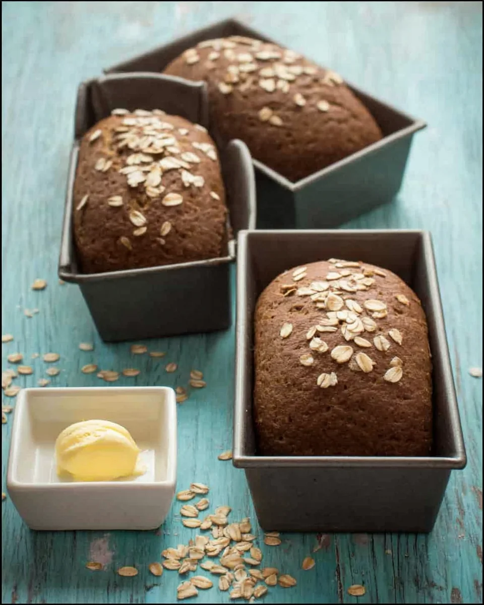 Outback Steakhouse Copycat Honey Wheat Bread in a pan next to butter.