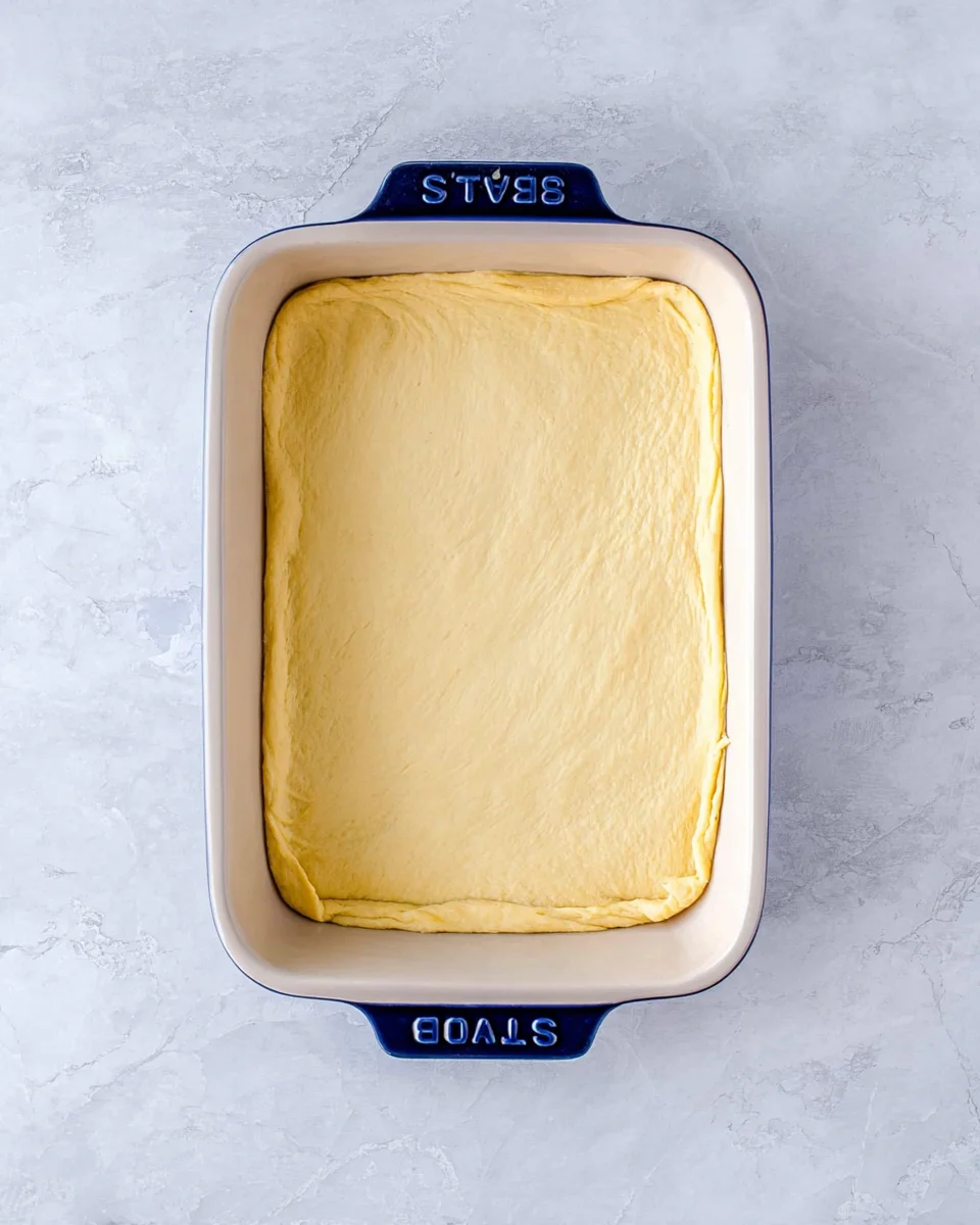 Crescent roll dough sheet pressed into bottom of baking dish.