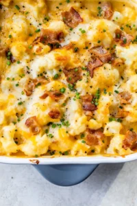 baking dish with cheesy cauliflower, bacon and chives