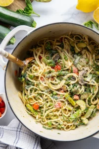 Loaded with a rainbow of spring vegetables and tossed in a creamy Parmesan sauce, this spring pasta primavera is easy to throw together and a beautiful pasta dish for any occasion.