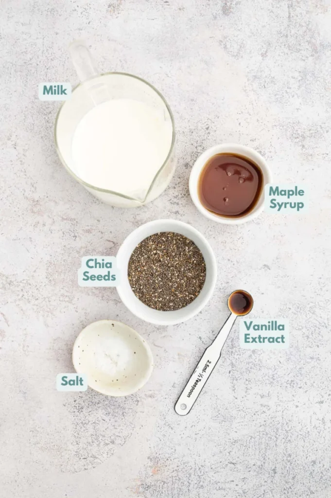 Ingredients for vanilla chia seed pudding in small bowls: milk of choice, chia seeds, maple syrup, vanilla extract, salt