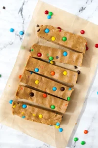 6 protein bars on a sheet of unbleached parchment paper.