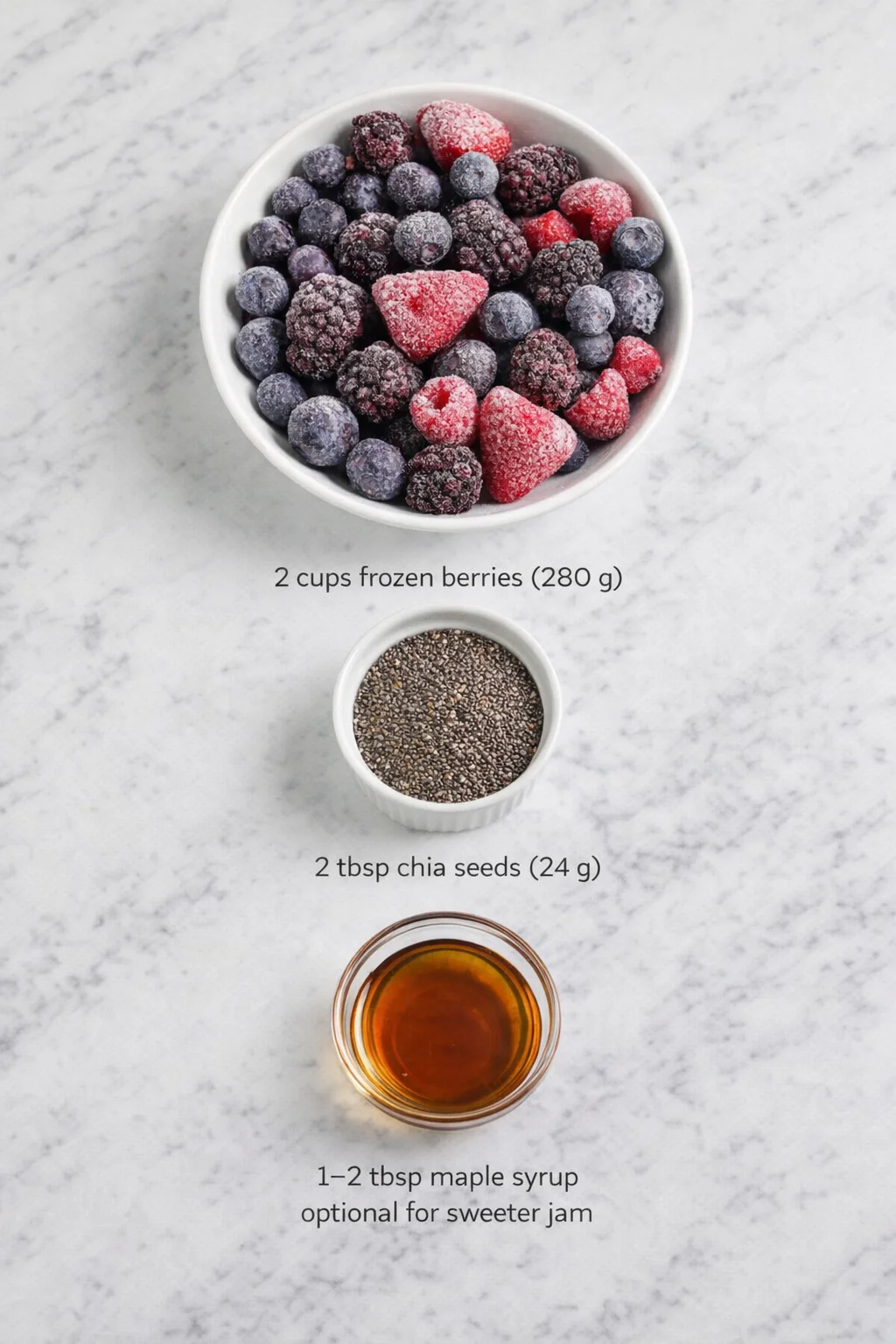 Measured ingredients arranged for How to Make Easy Berry Chia Seed Jam in Minutes: 2 cups frozen berries of choice, 280 g of blueberry, blackberry, raspberry, strawberry or a mixture, 2 tbsp chia seeds, 24 g, 1-2 tbsp ma