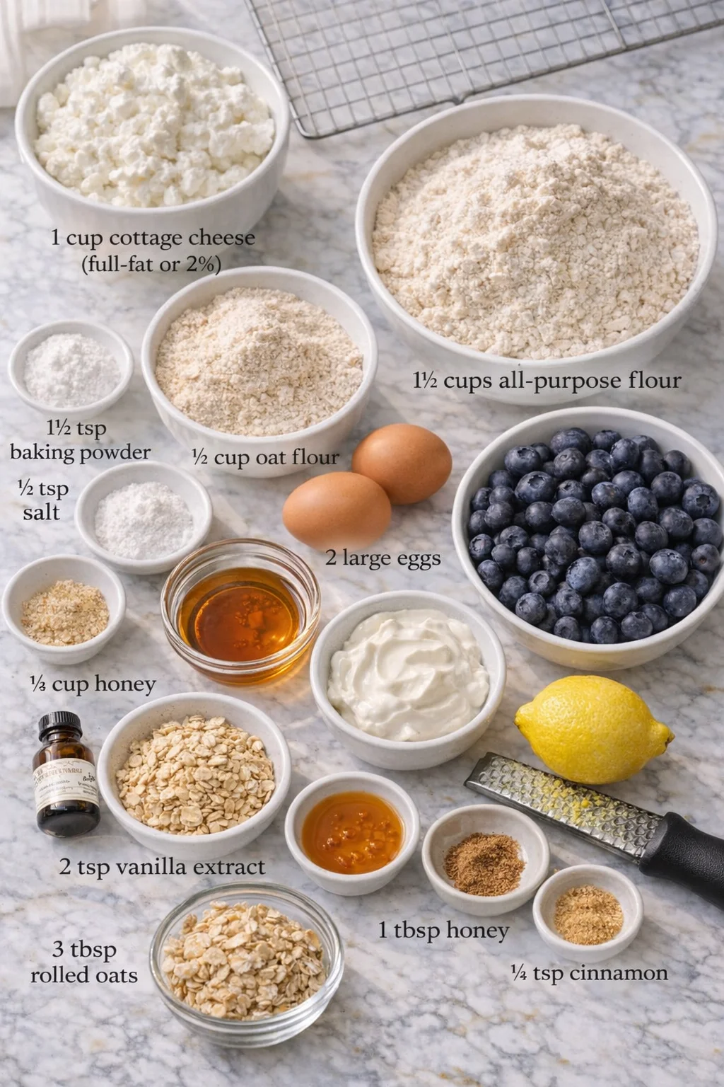 Measured ingredients arranged for Cottage Cheese Blueberry Muffins (High Protein) - SipNFeel: 1 cup cottage cheese (full-fat or 2%), 1½ cups all-purpose flour, ½ cup oat flour, 1½ tsp baking powder, ½ tsp baking soda, ¼ 