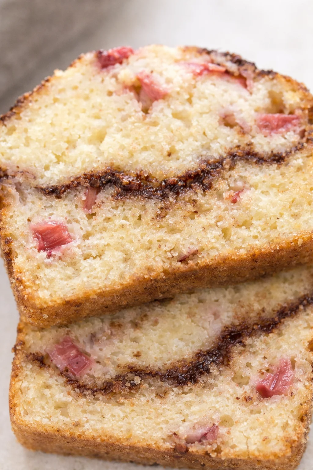Cinnamon Swirl Rhubarb Bread Close-up of sliced cinnamon swirl rhubarb bread with tart rhubarb chunks and cinnamon ribbon