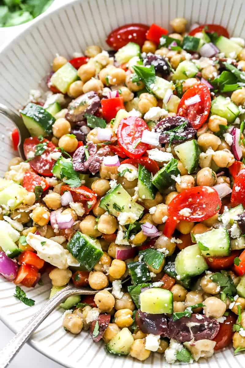 Colorful Mediterranean chickpea salad with fresh vegetables and feta cheese.