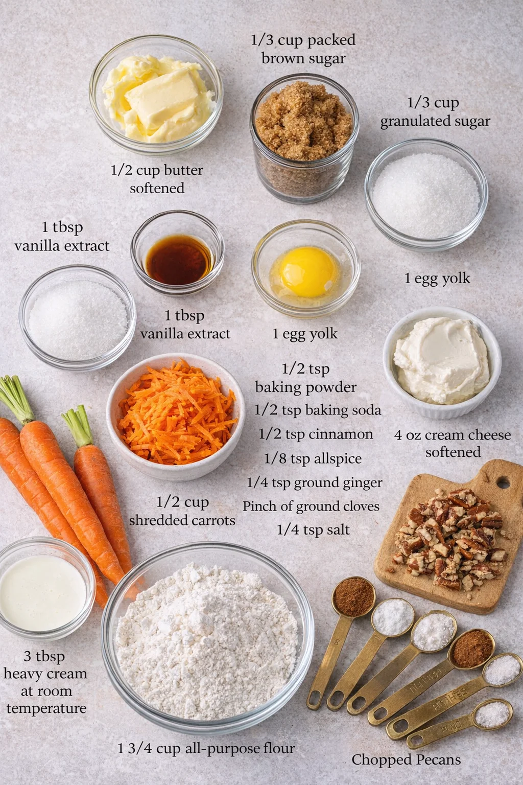 Measured ingredients arranged for Spiced Crumbl Carrot Cake Cookies: 1/2 cup butter softened, 1/3 cup packed brown sugar, 1/3 cup granulated sugar, 1/2 cup shredded carrots, 1 tbsp vanilla extract, 1 egg yolk