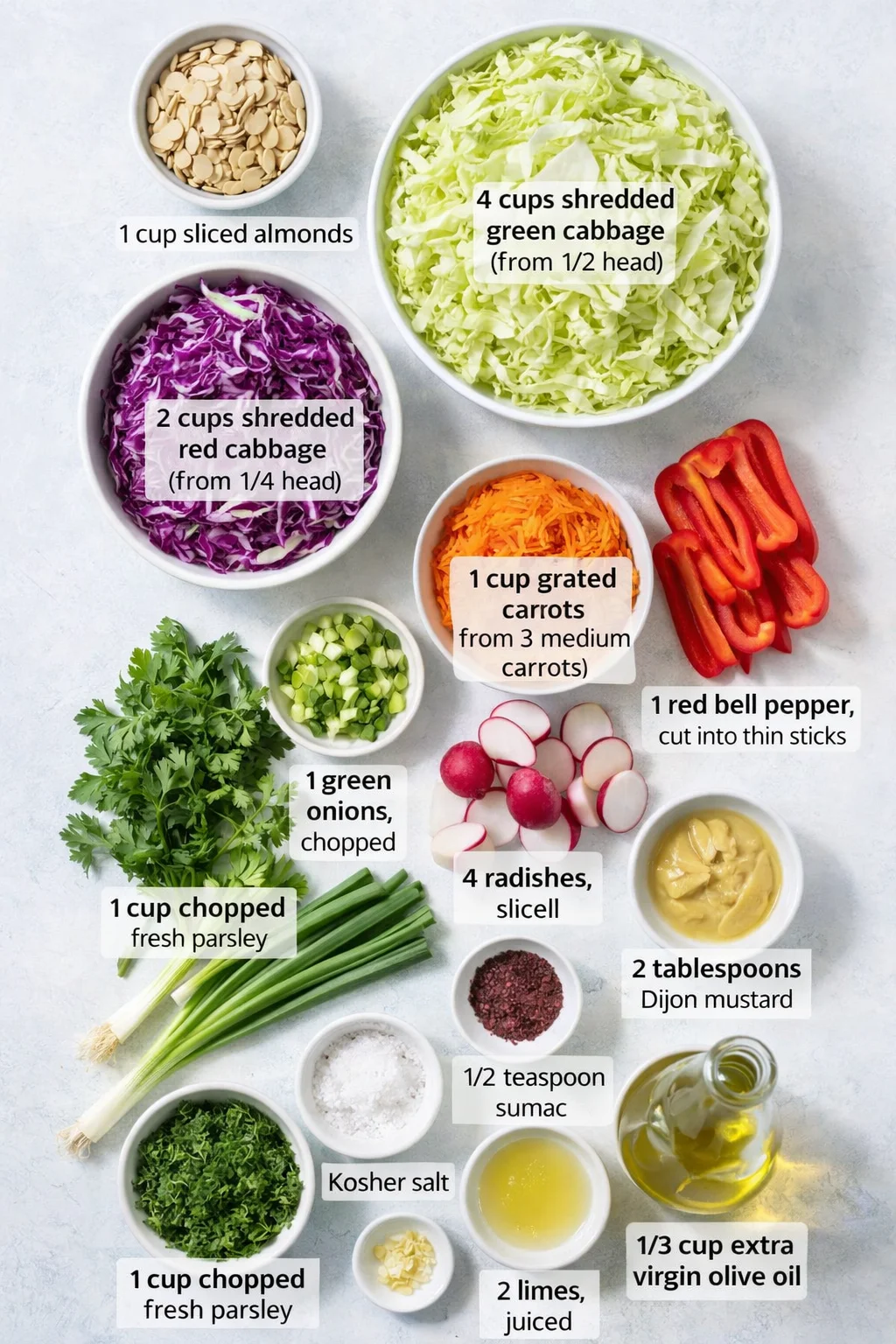 Measured ingredients arranged for Cabbage Salad: 1 cup sliced almonds, 4 cups shredded green cabbage (from about 1/2 head of green cabbage), 2 cups shredded red cabbage (from about 1/4 head of red cabbage), 1 cup grated 