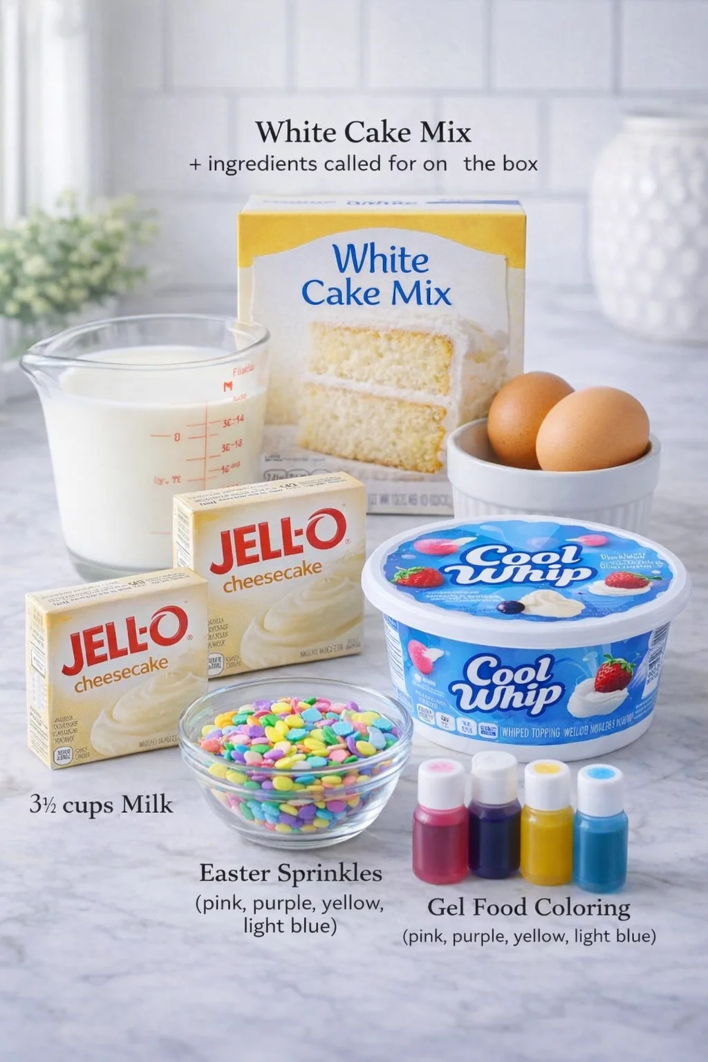Measured ingredients arranged for Easter Poke Cake with Cheesecake Pudding (Easy Bunny Cake Recipe): 1 box, 16 oz white cake mix + ingredients called for on the box, 2 boxes, 3.5 oz each instant cheesecake pudding mix, 3