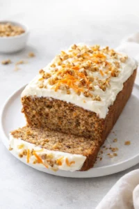 Final plated Carrot Loaf Cake Recipe (with Cream Cheese Frosting!) - Savory Nothings served as a hero shot
