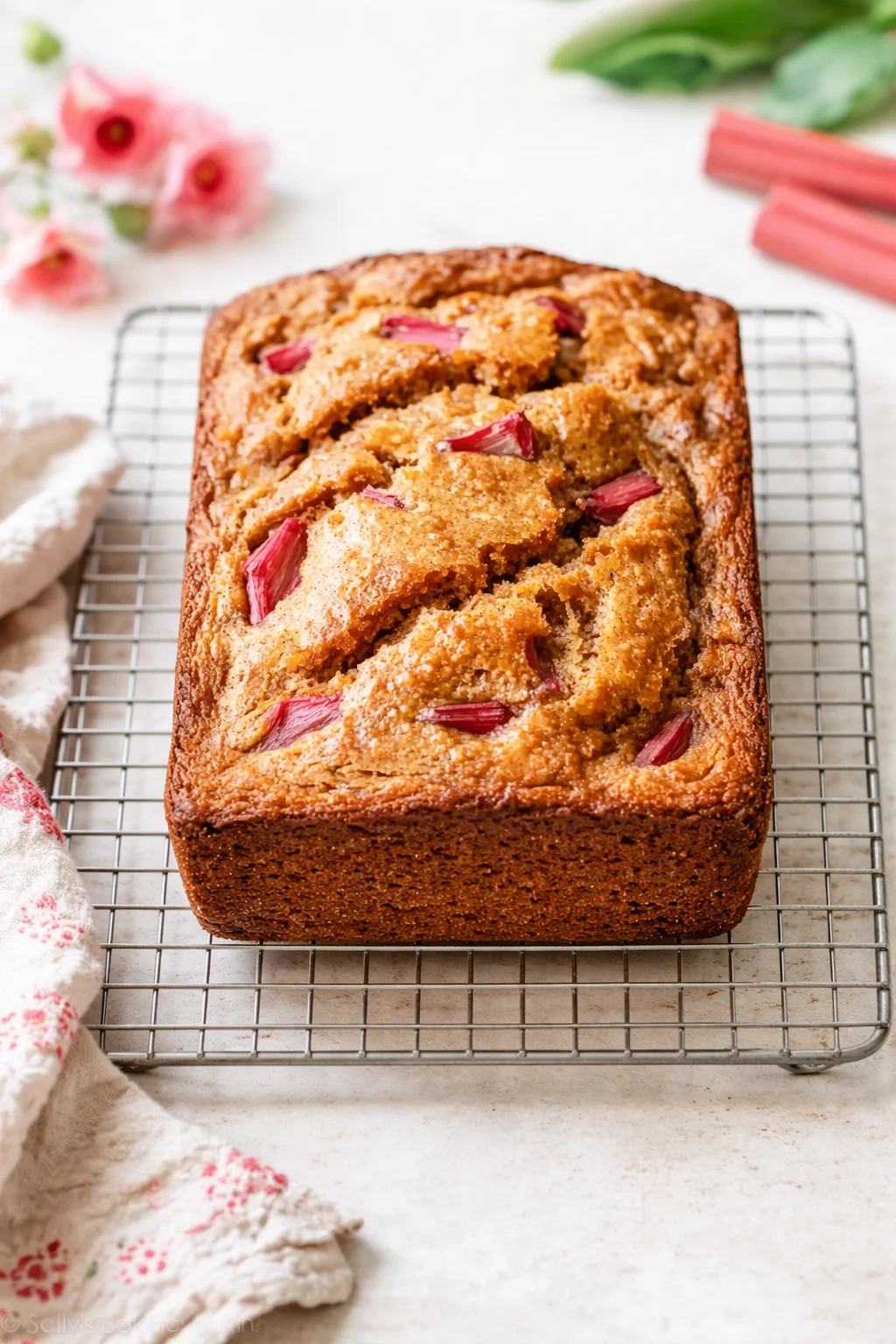 step-process-placeholder-9-10.png Loaf with toothpick inserted showing clean center, then cooling on wire rack after pan rest.