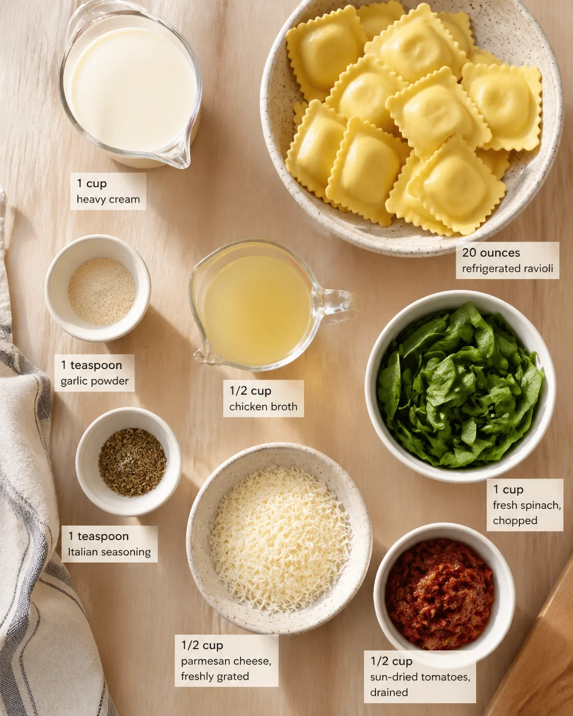 Measured ingredients arranged for Creamy Tuscan Garlic Ravioli: Easy & Flavorful Italian Dinner: 1 cup heavy cream, 1/2 cup chicken broth, 1 teaspoon garlic powder, 1 teaspoon Italian seasoning, 1/2 cup parmesan cheese, 