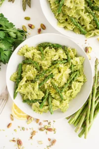 Top view of a white plate filled with asparagus pesto pasta