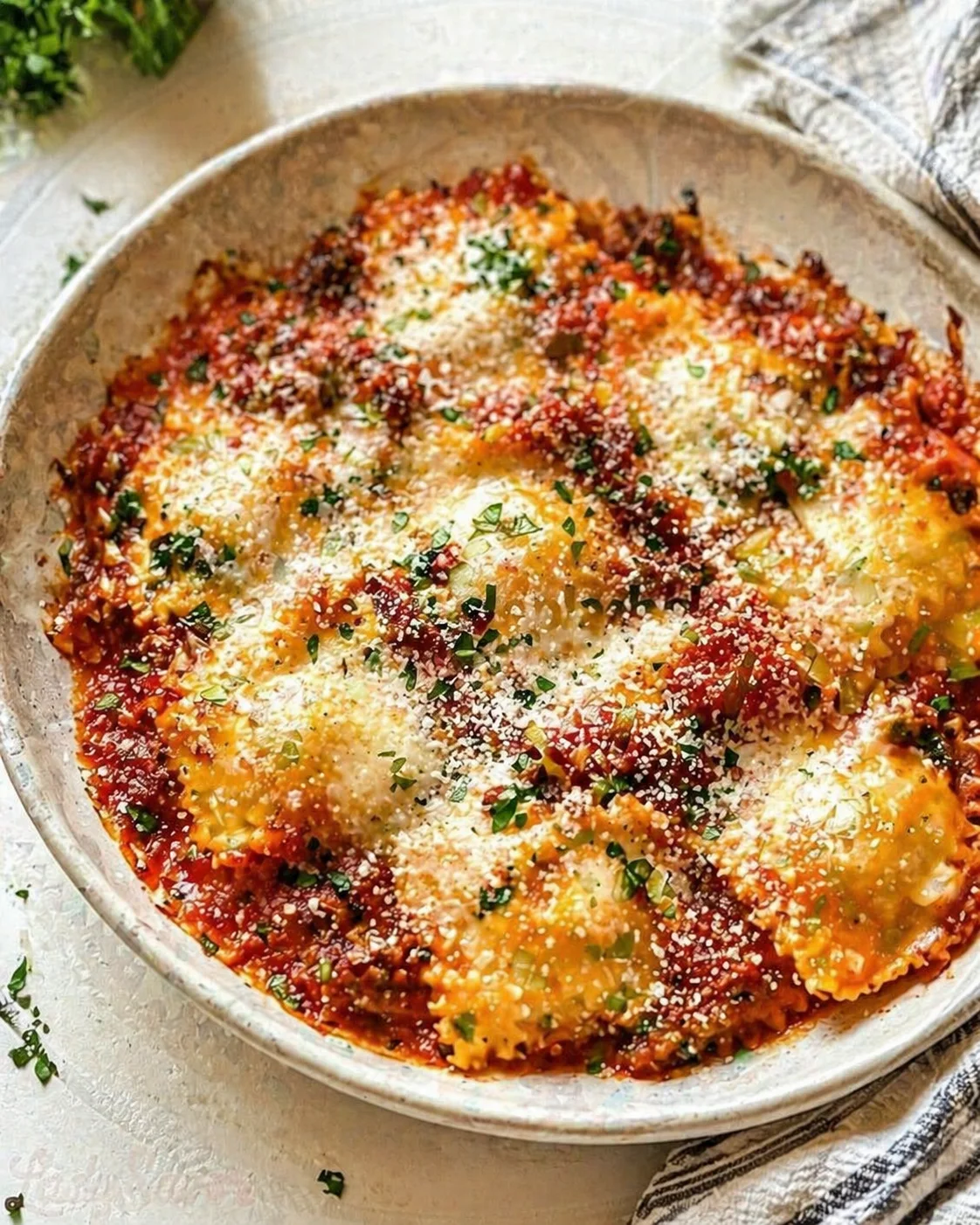 Single plated variation of Baked Ravioli shown in a natural kitchen scene