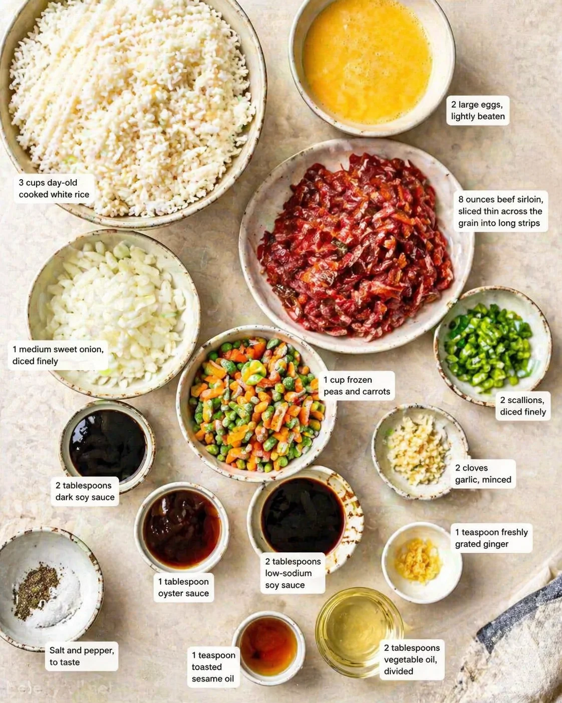 Measured ingredients arranged for Beef Fried Rice: 2 tablespoons dark soy sauce, 2 tablespoons low-sodium soy sauce, 1 tablespoon oyster sauce, 1 teaspoon toasted sesame oil, 2 tablespoons vegetable oil, divided, 2 large