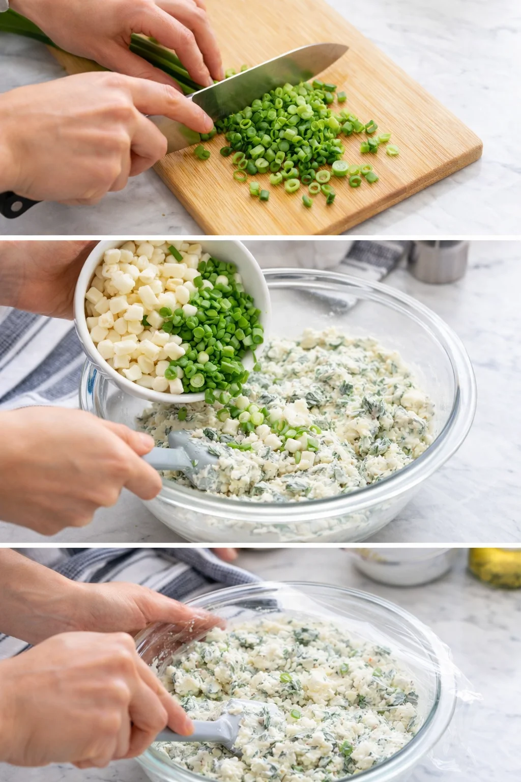 Hands chop green onions on a wooden cutting board, then add them to a creamy herb dip in a glass bowl.