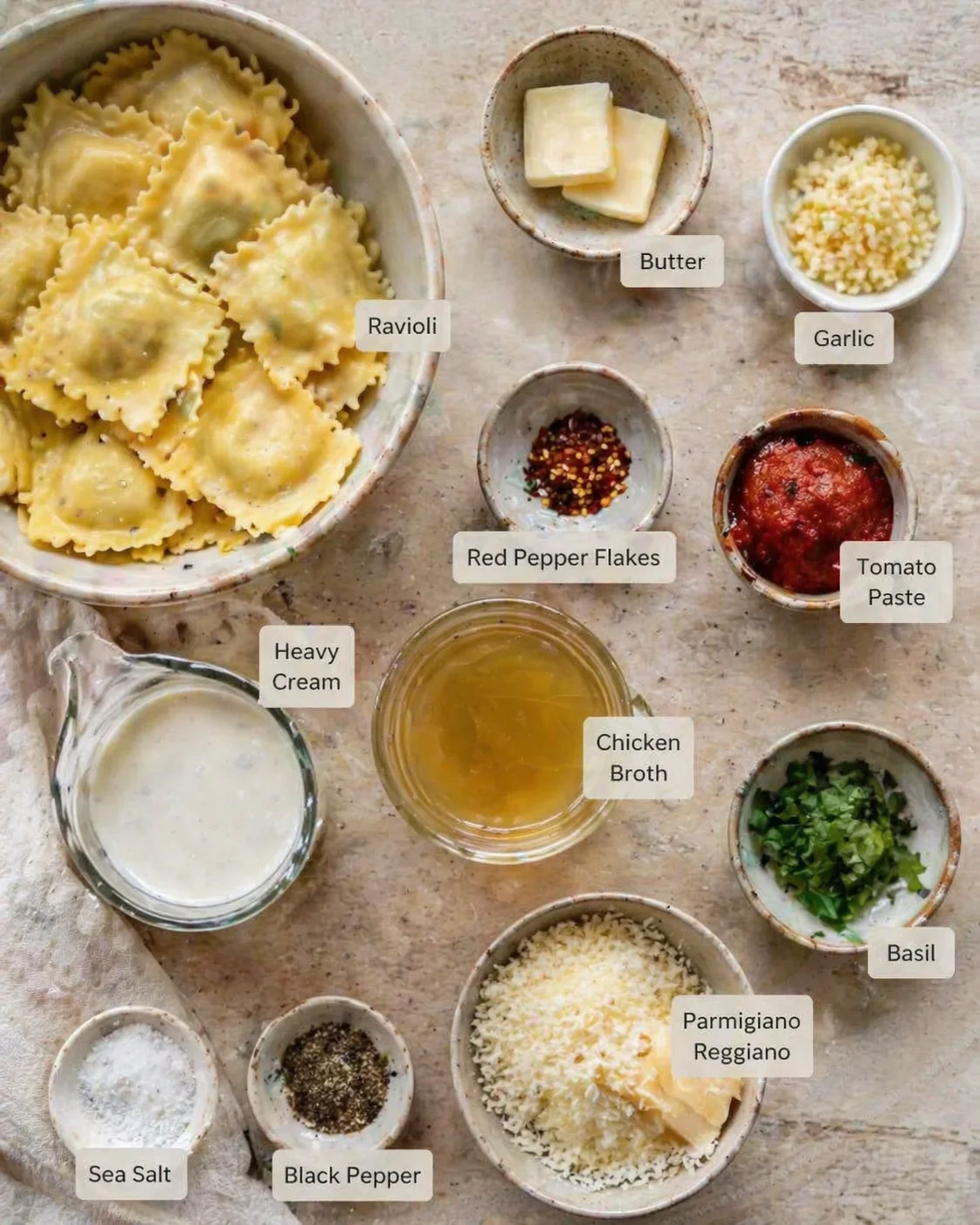 Overhead view of ravioli with labeled ingredients on a rustic table.