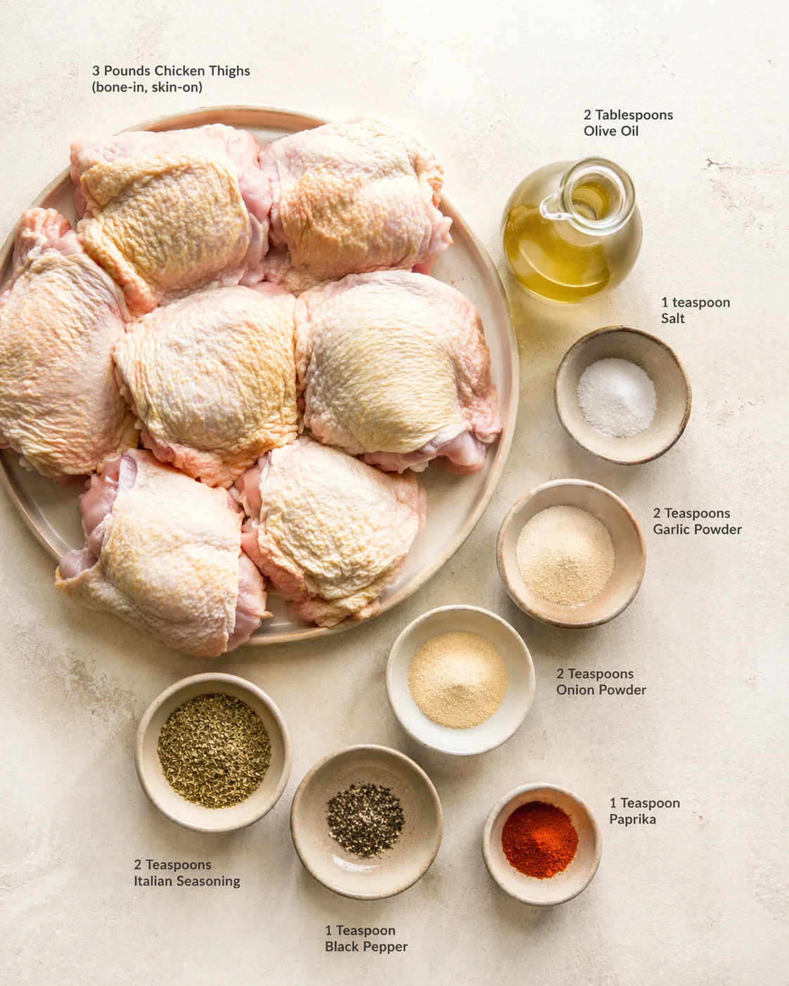 Raw bone-in, skin-on chicken thighs arranged on a plate with olive oil and spice bowls nearby.