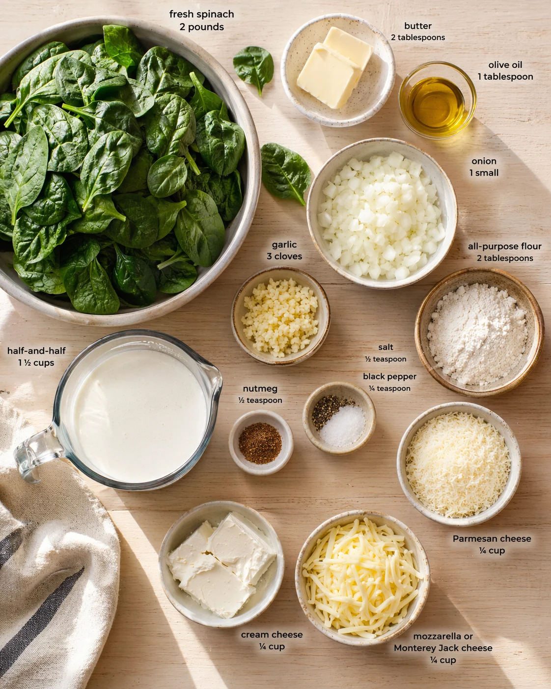 Top-down view of a wooden surface with spinach and labeled ingredients for a spinach dish.
