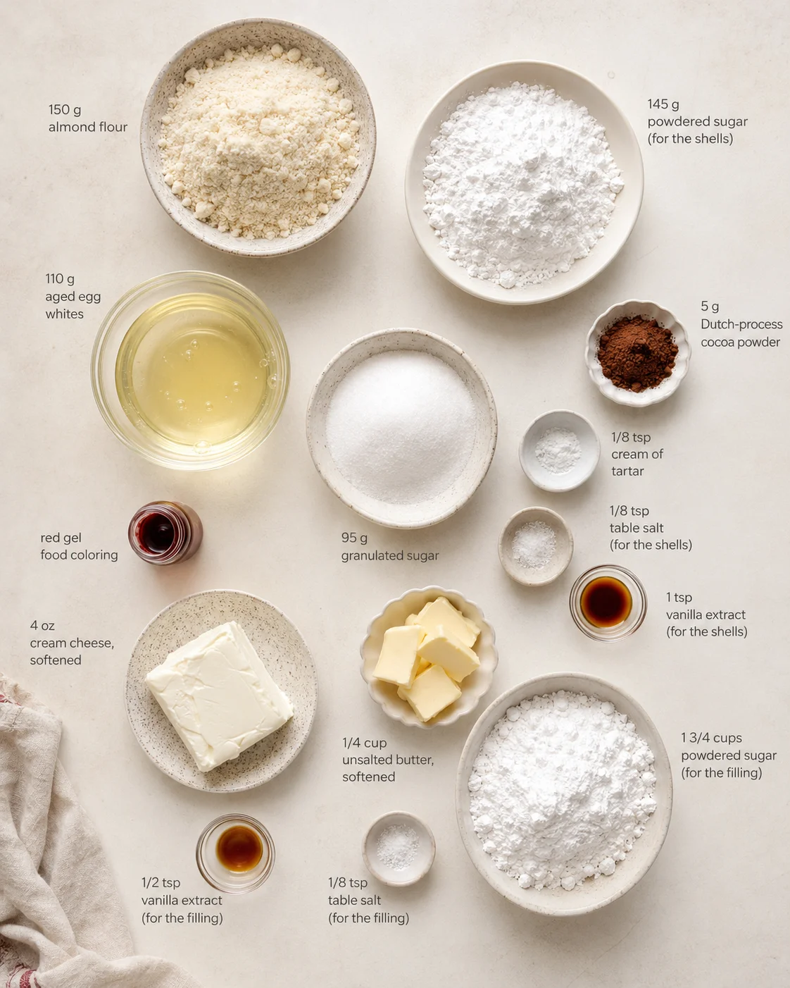 Overhead view of baking ingredients arranged in bowls and dishes with labeled measurements on a light beige counter.